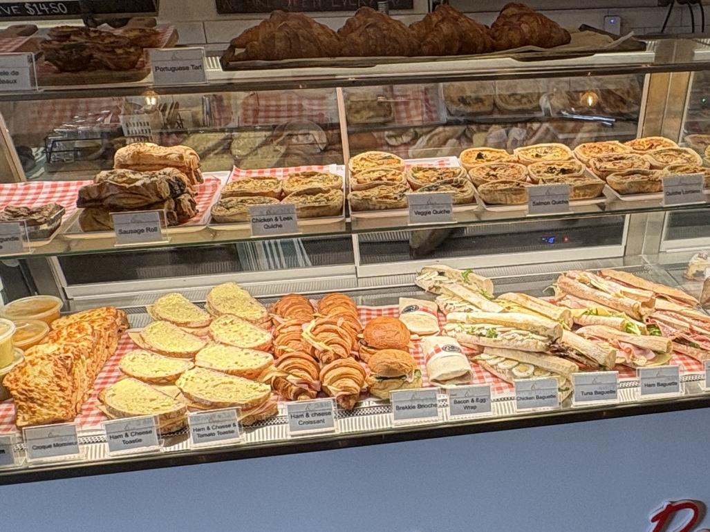 Sandwiches, quiches and croissants in the savoury counter at Éclair Boulangerie, Hampton