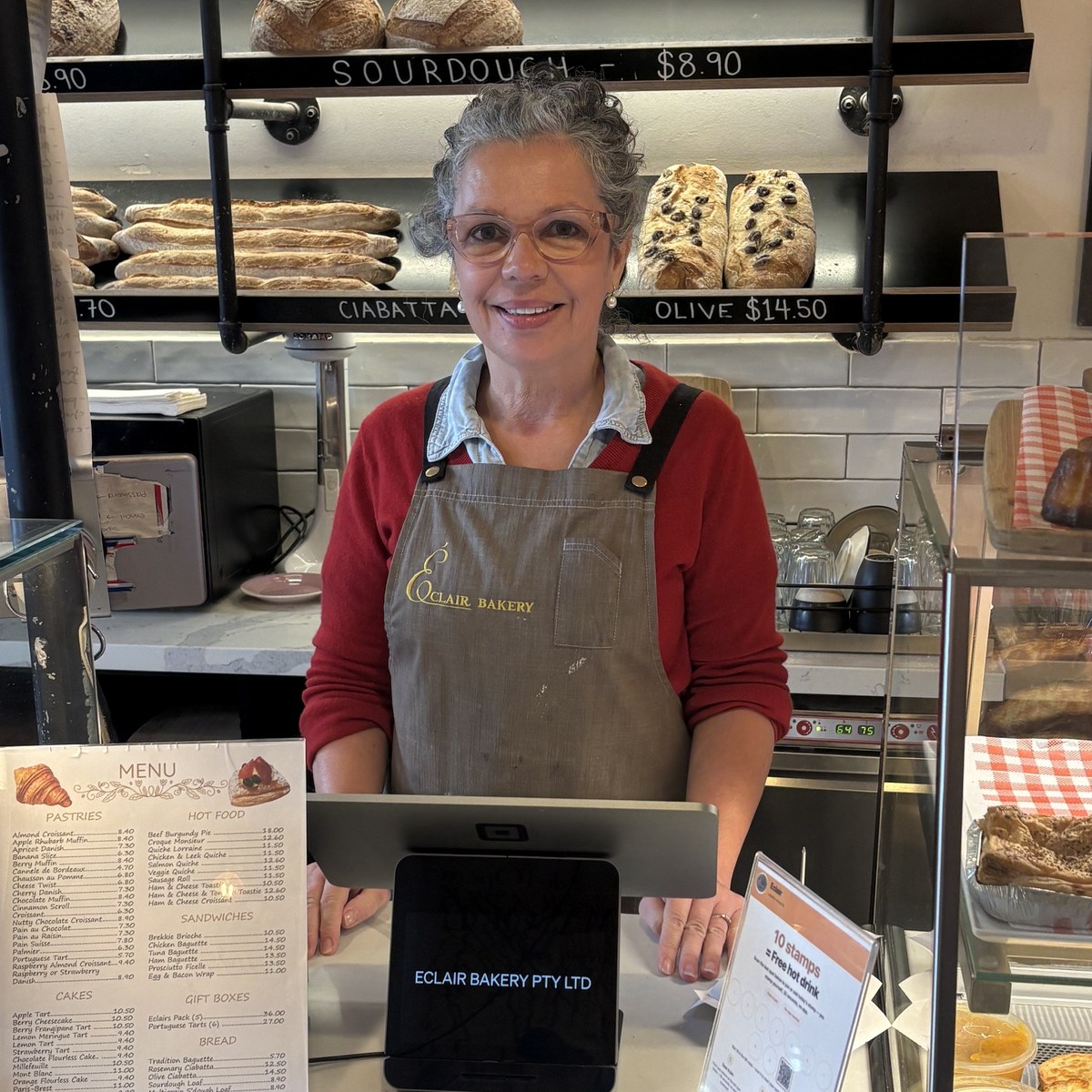 Patricia in the Éclair apron at the counter